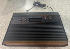 ATARI 2600 console with 25 games , 2 controllers and cords