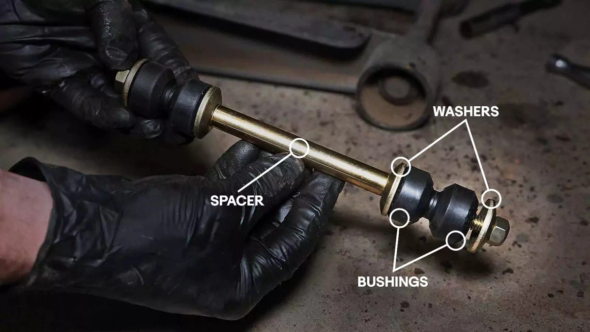 A mechanic pre-assembles the end links.