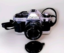 Canon AE-1 Program 35mm SLR with 50mm 1.8 Lens, protective case and travel bag.