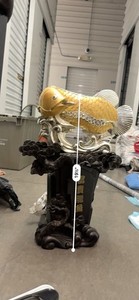 This is a golden Arowana fish statue