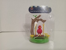 red parrot on a swing solar dancer