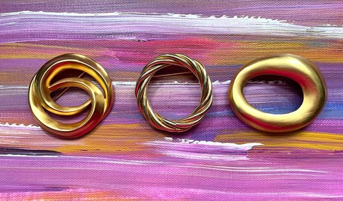 Asymmetrical vintage gold tone pin and two more round ones