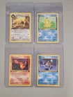 4 1st Editions Pokémon Cards. Squirtle, Psyduck, Charmander, Dark Persian.