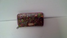 sakroots pink flowed zipper wallet with lots of storageand coin zipper.