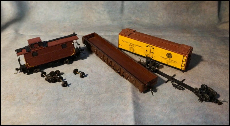 A Lot of HO Scale Model Train Railroad Cars in Need of Repair and