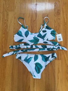 white swimsuit with green leaves