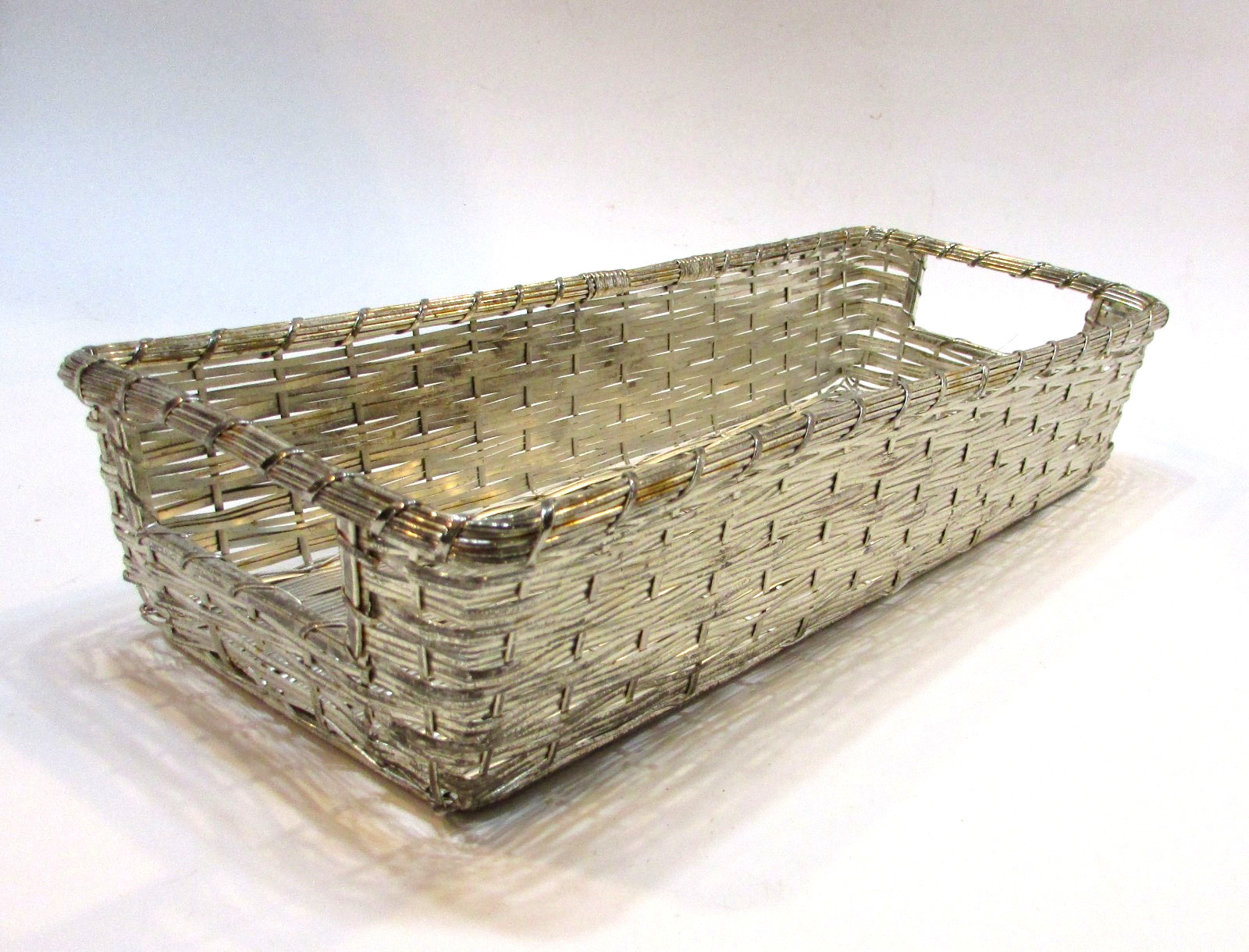 Woven silverplate rectangular bread basket with two handles.