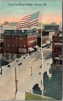 1913 AURORA Illinois Postcard ''East Fox Street Bridge'' Downtown View / U.S. Flag