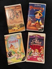 4 Disney VHS in Clamshell - Alice in Wonderland, Pinnochio, Old Yeller, Bambi