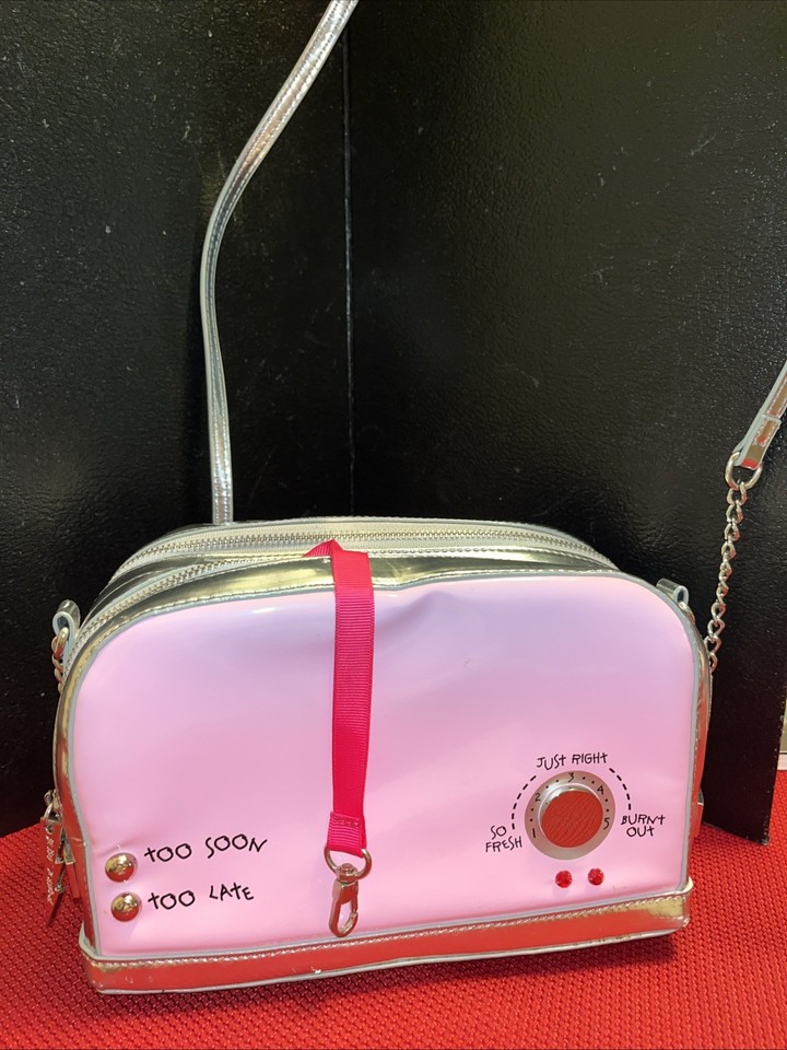 A Betsey Johnson bag shaped like a champagne toast is peak kitsch — wearable art for the person who treats accessories as conversation starters.