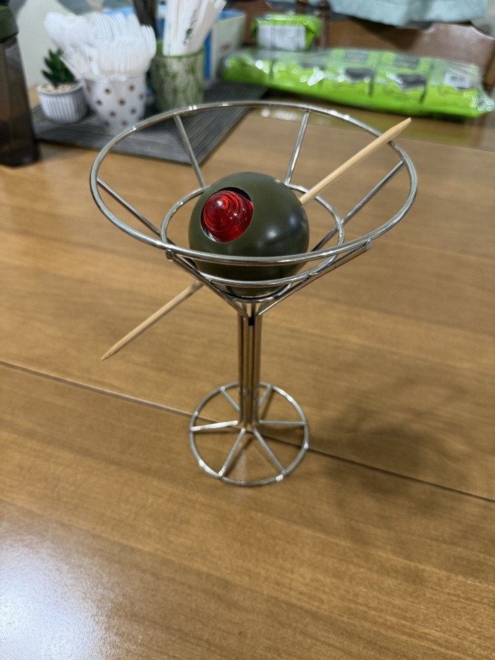 A 1993 sculptural Martini Lamp by artist David Krys — a giant olive-in-glass table lamp that is equal parts cocktail art and conversation-starting interior design.