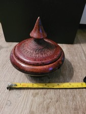 Handmade reddish-brown WOOD lidded jar features a distinctive texture