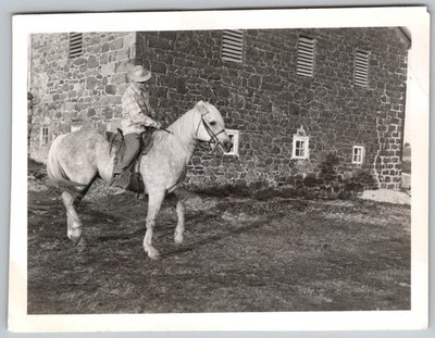 Vtg B&W Snapshot Man In Plaid Shirt & Hat Riding Horse Stone Barn Farm 1955