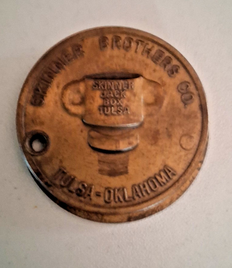 A solid brass oilfield thread gauge doubling as a key fob — hyper-specific industrial artifact that's also genuinely pocketable.
