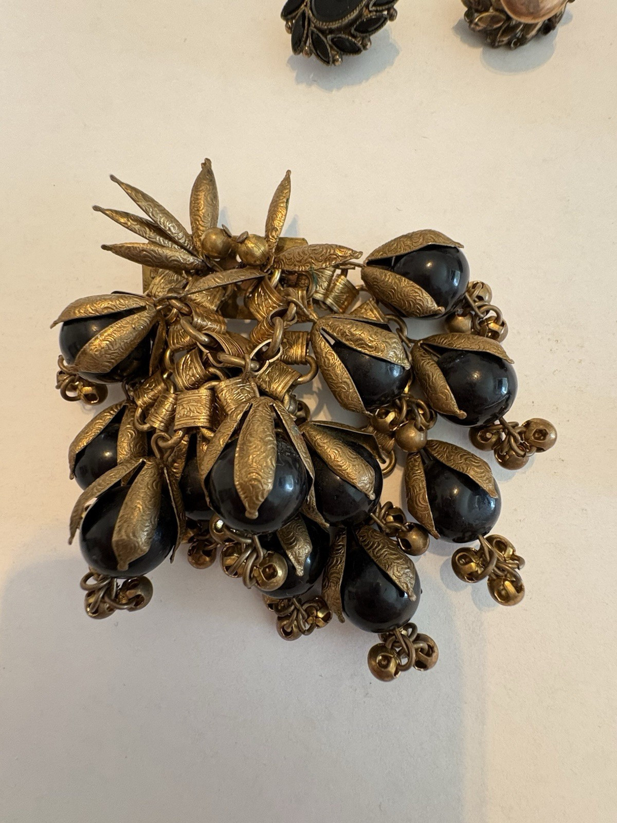 Vintage Miriam Haskell Brass Cluster Brooch with Black Glass Cabochon Stones
