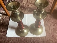 VINTAGE PAIR OF SILVER COLOURED METAL CANDLESTICKS WITH RED BARREL