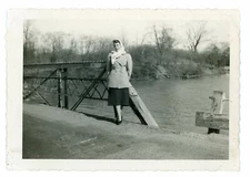 Black & White Picture Snapshot Photo Of A Lady Standing In Front Of A Bridge