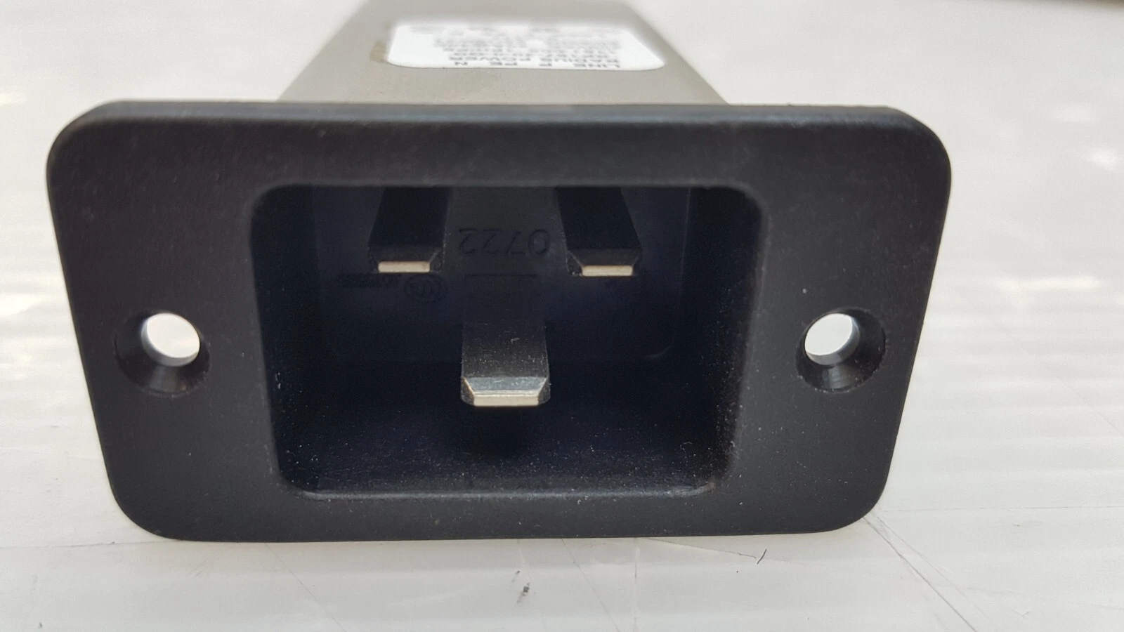 IEC C20 inlet face of the Radius Power RP187-20 line filter with mounting flange