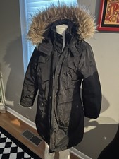 Black Steve Madden faux fur hooded jacket. Girls size 14.  Four front pockets.