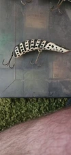 Vintage Kautzky Lazy Ike 3 fishing lure in a black and white striped pattern.