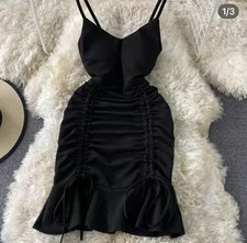 Elegant black dress with ruched detailing and spaghetti