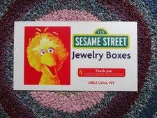 Advertising sign for Sesame Street Jewelry Boxes Feat. Big Bird MELE Utica NY