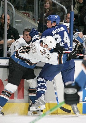 Bryan McCabe Toronto Maple Leafs is taken into the boards by- Ice Hockey Photo