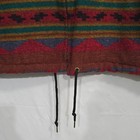 Red, brown, and cream Vtg Navajo hooded coat with black triangle patterns and two black drawstrings.