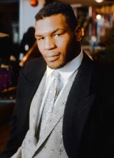 Mike Tyson poses for a photo while fitted for a suit during a phot- Old Photo 2