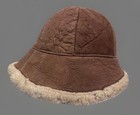 Brown suede bucket hat with creased crown, tan fleece lining, and dark brown rubber sole, made in USA.