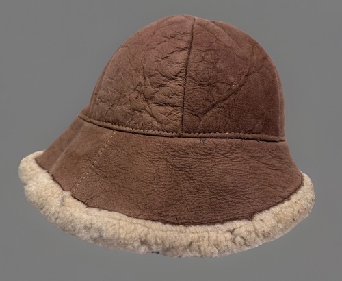 Brown suede bucket hat with creased crown, tan fleece lining, and dark brown rubber sole, made in USA.