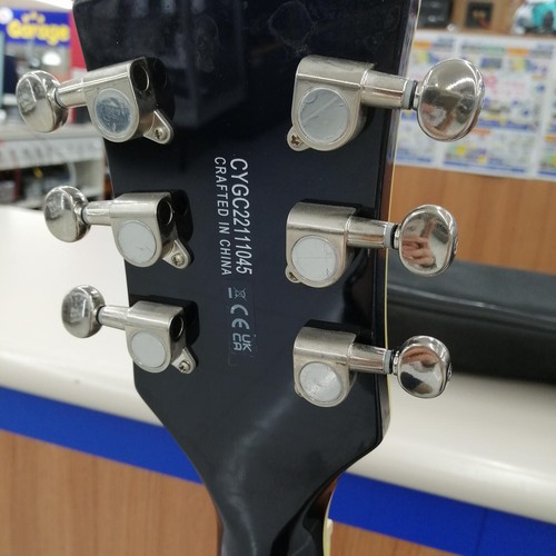 Black GRETSCH G5655T-QM hollow body electric guitar with silver hardware and six chrome tuning pots on the back.