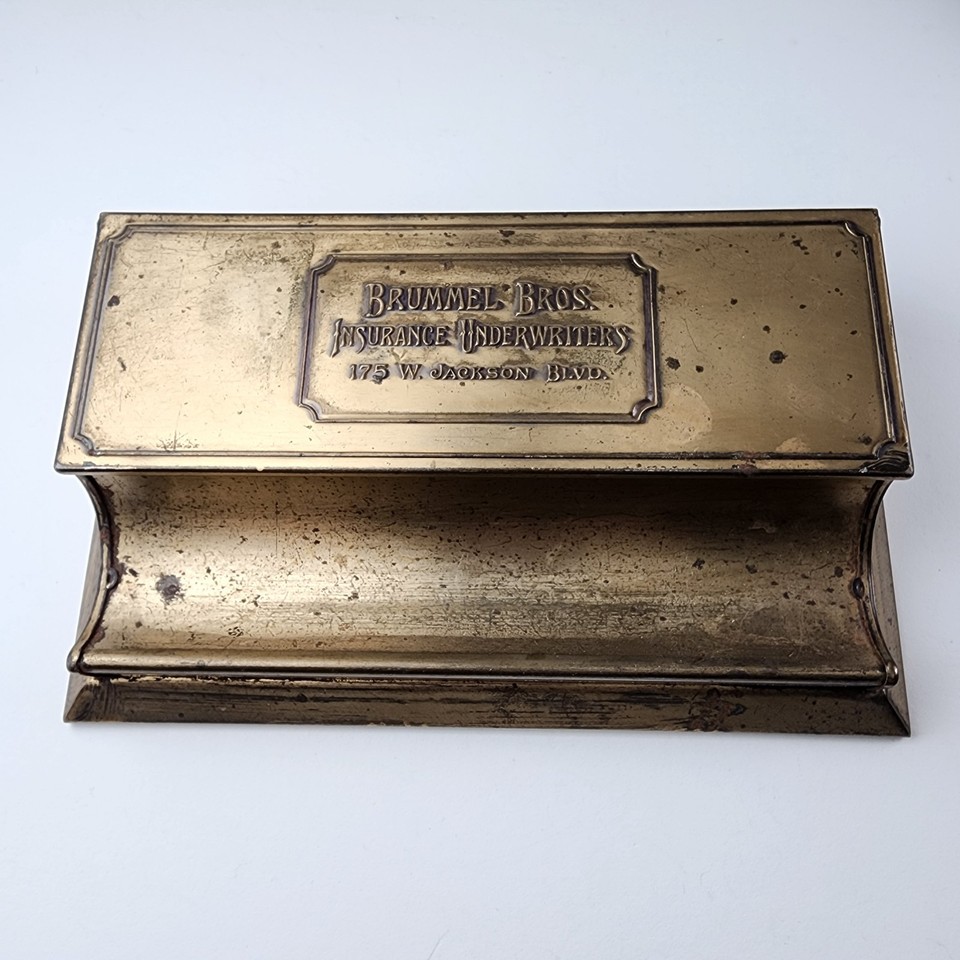 A genuine antique brass stamp box from Brummel Bros. Chicago — a tiny, weighty piece of American commercial history that doubles as a perfect desk object.