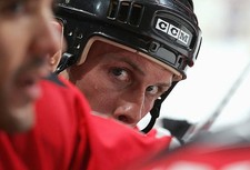 Dan McGillis New Jersey Devils looks on from the bench at a - Ice Hockey Photo