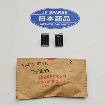 NOS Nissan Datsun Bluebird 810 Emblem Fastener 48423-47410 Genuine 2x 486 - Bild 1 von 4