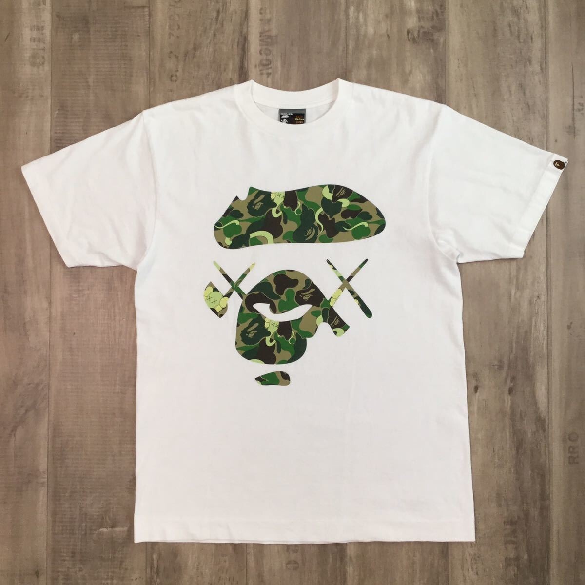 BAPE × kaws ABC camo green Big face T-shirt NIGO White A BAPE × kaws ABC camo green Big face T-shirt NIGO White A