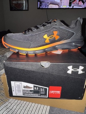 Under Armour Charged Assert 9 Black/Orange Men s Lace Up Low Top Sneaker 3024590