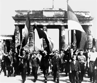 Berlin: East Berliners march through Brandenburg Gate flags waving- 1953 Photo