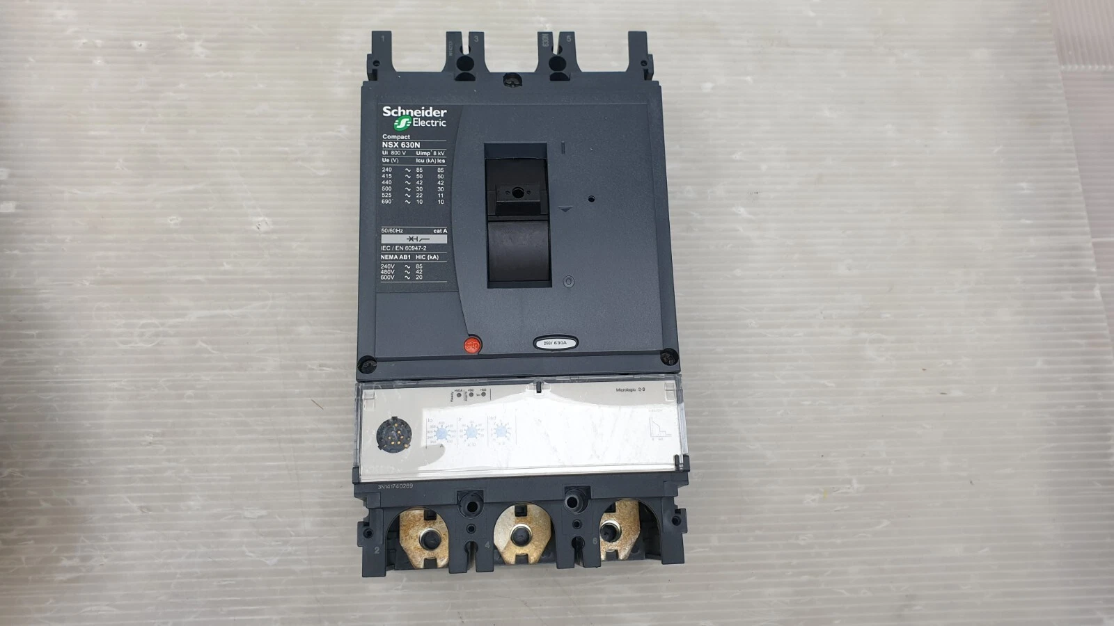 Front of the Schneider LV432893 Compact NSX630N with Micrologic 2.3 trip unit dials and terminals