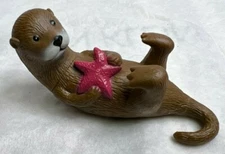 Ankyo Otter hard plastic figure holding a starfish lying on back 6" long 