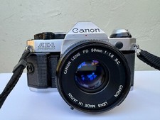 1980's Canon AE-1 Program Film Camera, Flash, Manual, and Storage Bag