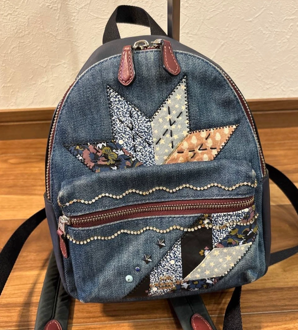 coach denim patchwork backpack Blue Shoulder Bag – Rediscover Vintage Denim and smooth leather Inside zip and multifunction pockets Zip closure fabric lining Top handle with 2 drop Outside zip pocket Adjustable shoulder straps 7 1/2 (L) x 9 1/4 (H) x 3 3/4 (W) Style No. COACH Vintage DENIM Patchwork Ergo