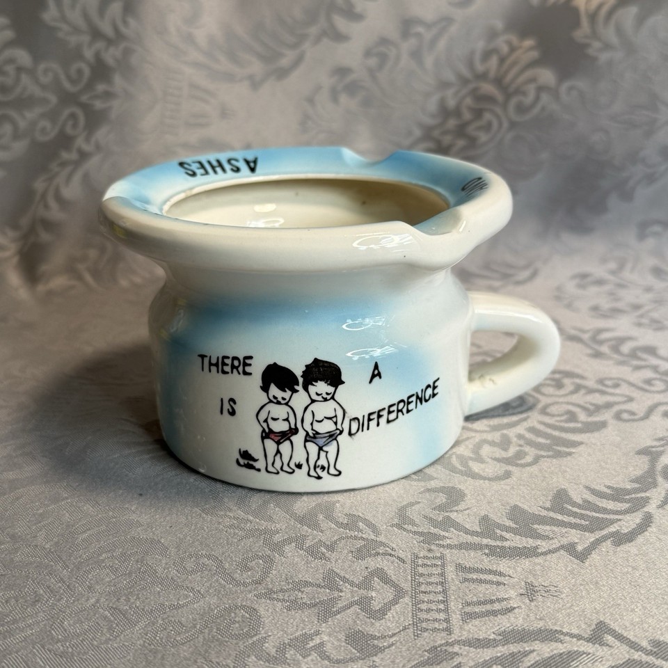 A vintage ceramic ashtray with novelty/funny design — the kind of kitschy mid-century desk piece that doubles as a conversation-starting catch-all today.