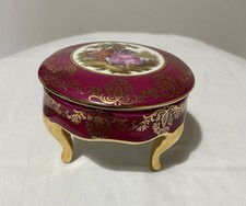 A Limoges porcelain trinket box with a courting couple scene and gilt decoration