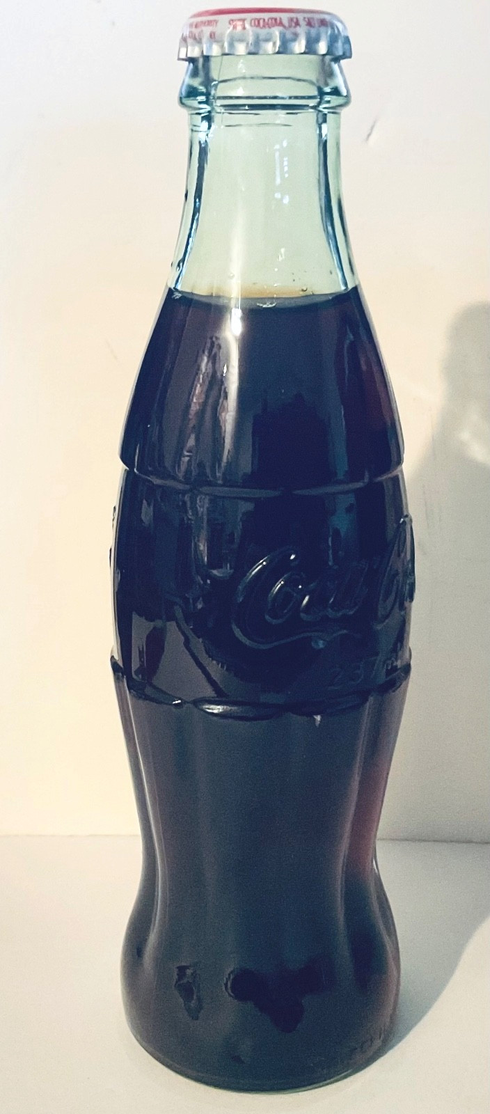 Coca-Cola Classic Tinted Glass Bottle (full) with Red Cap 8o