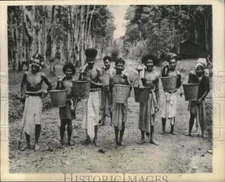 1944 Press Photo Laborers carry buckets of latex at New Guinea rubber plantation