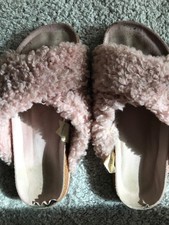 Worn used ladies pink fluffy slippers