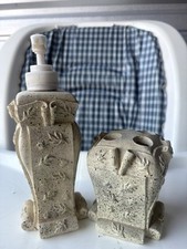 bathroom accessory set, featuring a soap dispenser, matching toothbrush holder