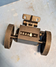 Trumeter measuring meter with double wheel and mounting bracket.