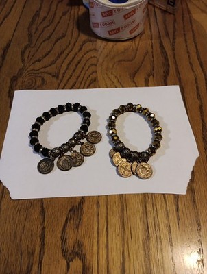 2 St Benedict Stretch Bracelets. 1 Black And One Gold Tone.